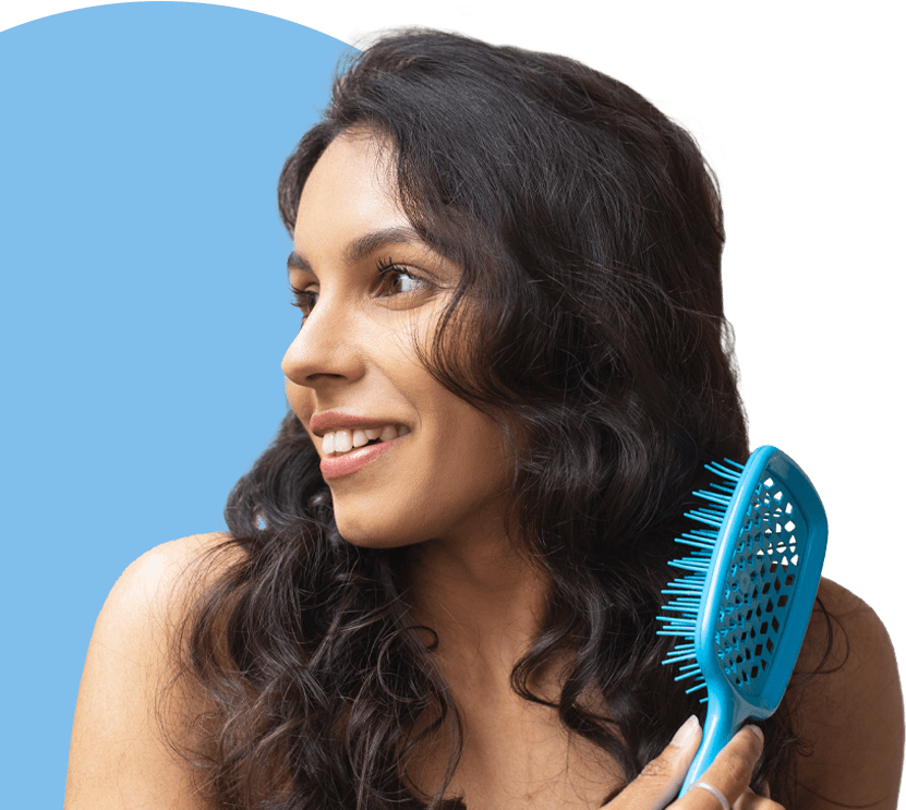lady brushing new hair after hair loss treatment