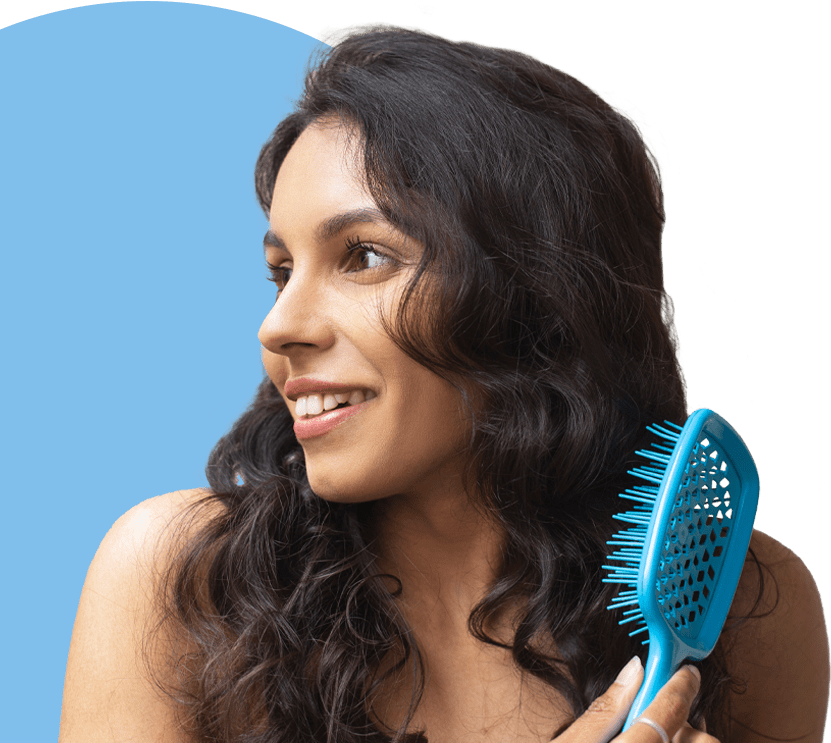 SecondaryImageTitleTag lady brushing new hair after hair loss treatment